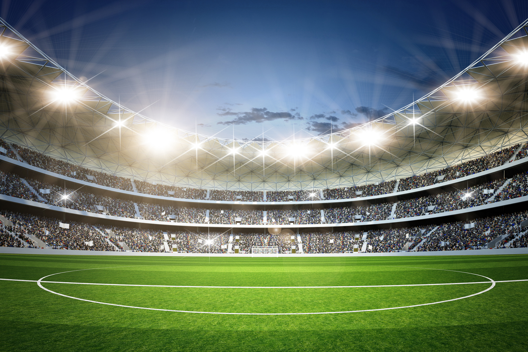 Großes Fußballstadion mit Flutlicht und voller Tribüne als Public-Viewing-Fanzone.
